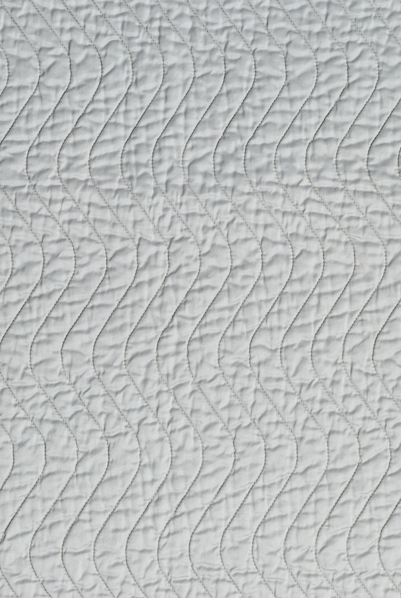 Cloud: A close up of quilted cotton sateen fabric in cloud, a soft, subtle sky blue-grey.