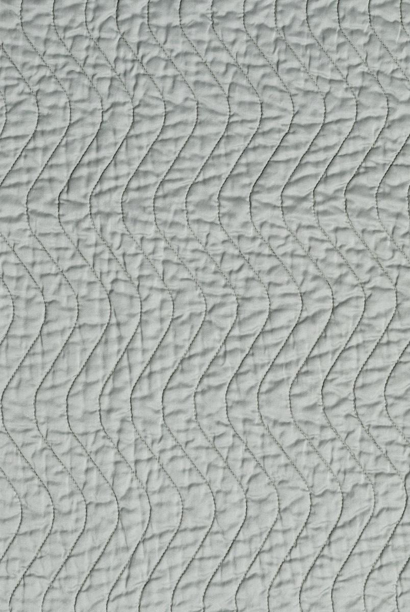 Eucalyptus: A close up of quilted cotton sateen fabric in eucalyptus, a soft light green.