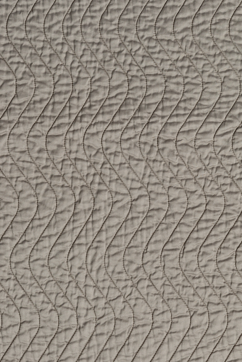 Fog: A close up of quilted cotton sateen fabric in fog, a neutral-warm, soft mid-tone grey.