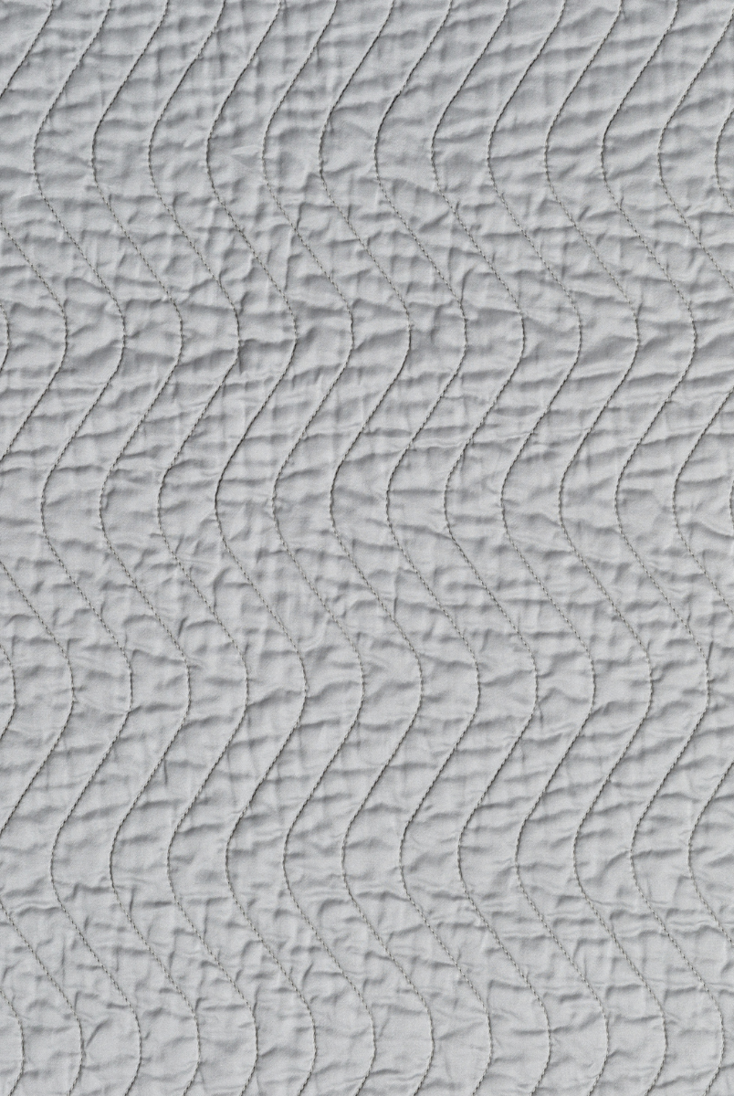 Mineral: A close up of quilted cotton sateen fabric in mineral, a soothing seafoam blue with subtle grey-green undertones.