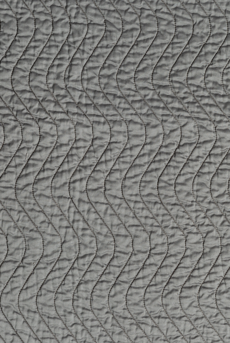 Moonlight: A close up of quilted cotton sateen fabric in moonlight, a saturated, cool, mid-dark grey tone.