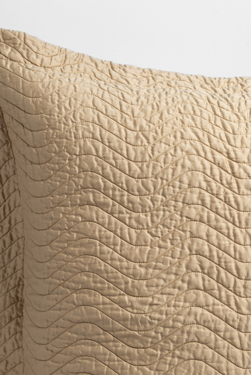 Honeycomb: a close up of a pillow corner showing the flange framing quilted cotton sateen shot against a white background. 